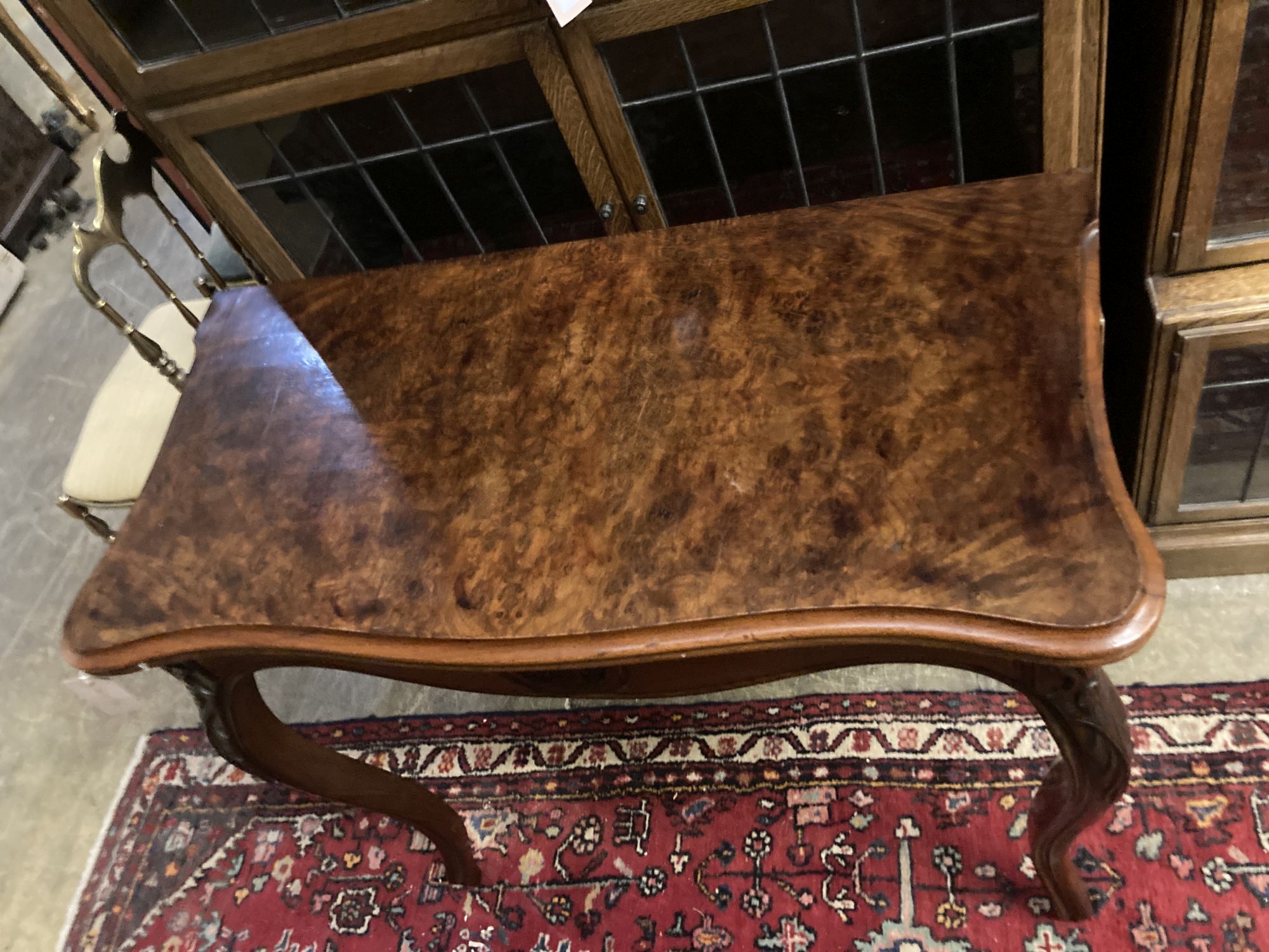 A 19th century French walnut serpentine folding tea table, width 85cm, depth 42cm, height 76cm